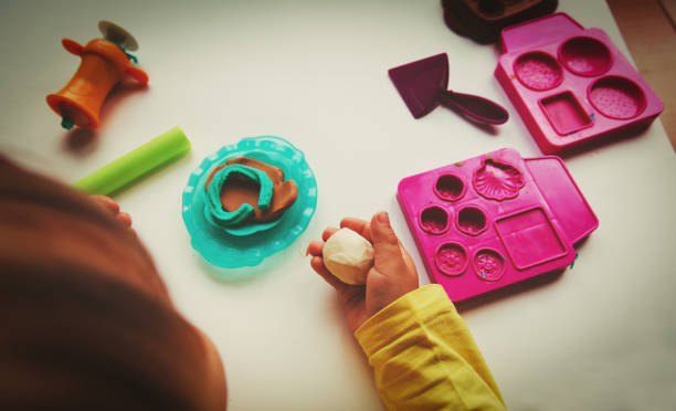 istock Child playing with clay molding shapes 869234720