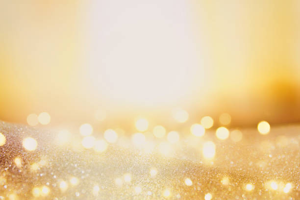 istock glitter vintage lights background. dark gold and black. de focused. 869235202