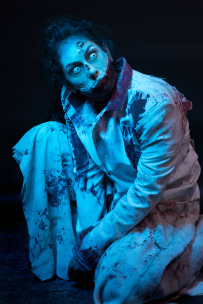 istock Female Zombie white eyed nurse with slashed neck 869238356