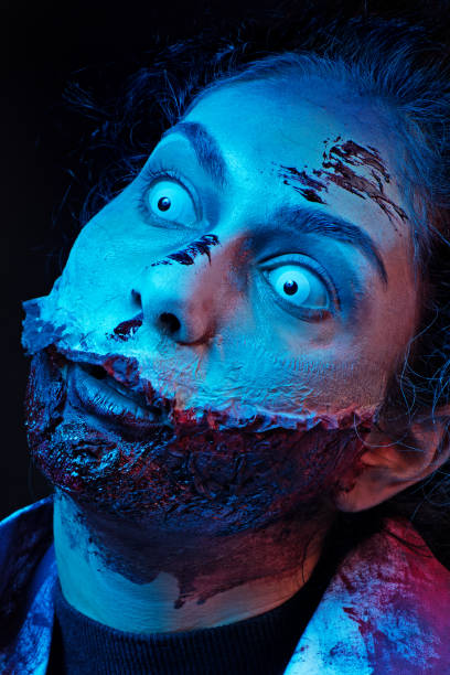 istock Female Zombie white eyed nurse with slashed neck 869238504