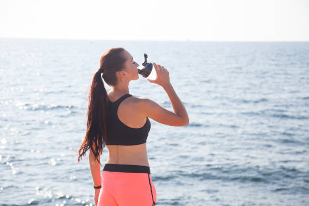 istock girl after sport classes drinks water 869242832