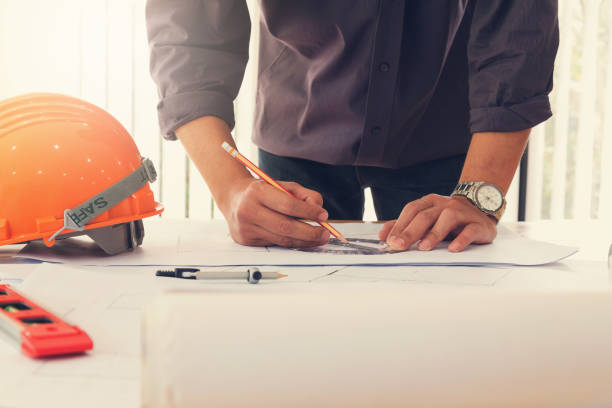 istock Architect concept, Architects working with blueprints in the office, Vintage Effect 869243260