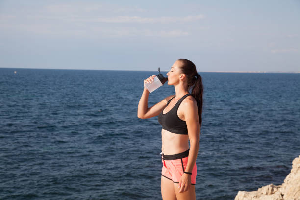 istock Fitness girl drinks water sport training 869245786