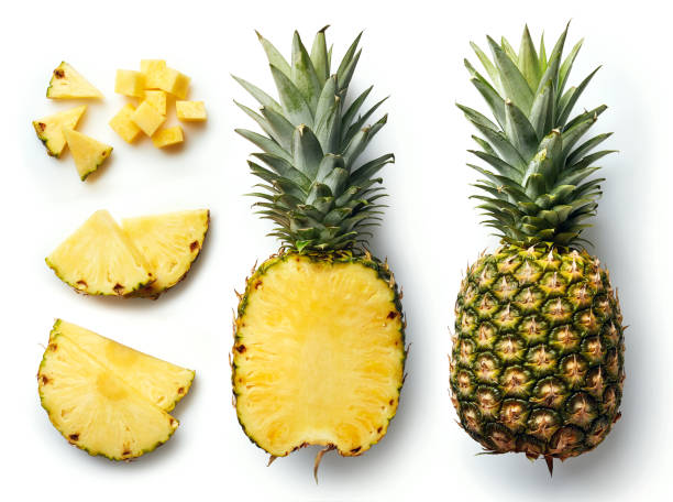 Fresh pineapple isolated on white background Fresh whole and cut pineapple isolated on white background. From top view halved stock pictures, royalty-free photos & images