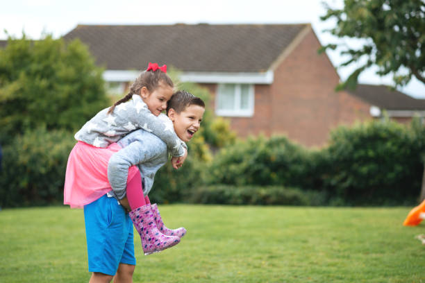 istock Brother and sister doing a piggyback carry 869246376