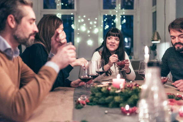 istock young people eating dessert at christmas table 869254046