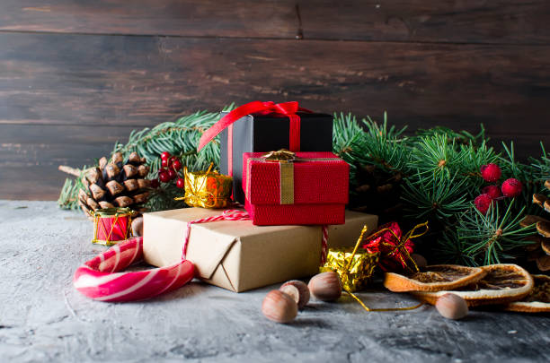 istock Red christmas  gift  box with red ribbon and fir branches 869257732