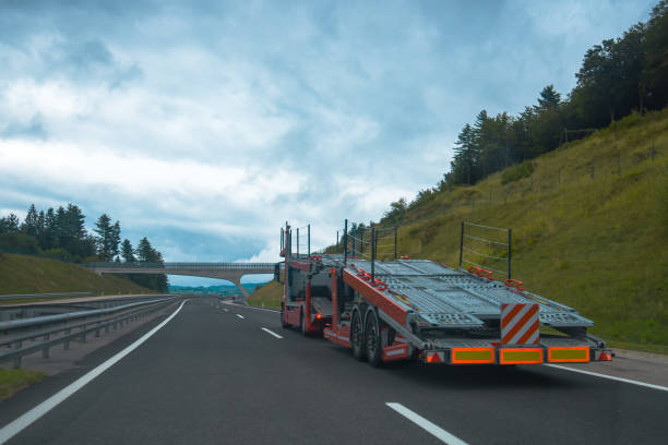 istock Semi truck with empty car carrier trailer 869258546