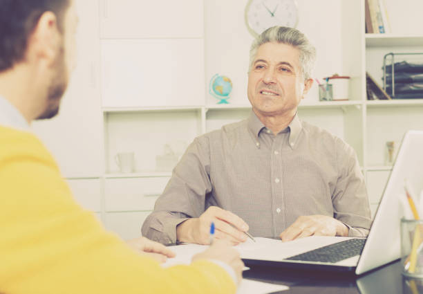 istock Men sign credit agreement 869262754