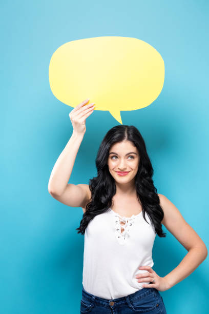 istock Young woman holding a speech bubble 869262908