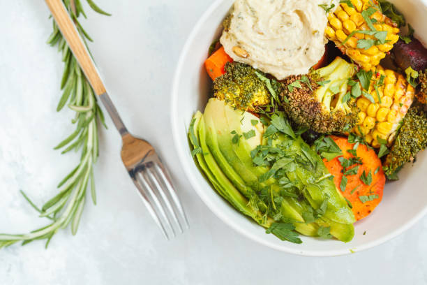 salad with baked vegetables, hummus and avocado