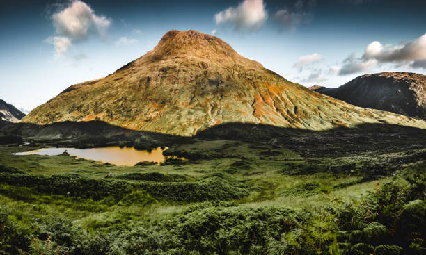 Stob Dubh - Glen Etive A panorama of Stob Dubh in Glen Etive as the sunset begins casting long shadows in the valley. etive river photos stock pictures, royalty-free photos & images
