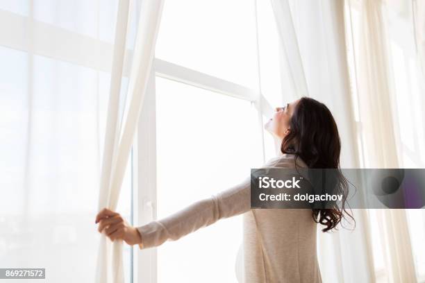 Close Up Of Pregnant Woman Opening Window Curtains Stock Photo - Download Image Now - Curtain, Women, Indoors