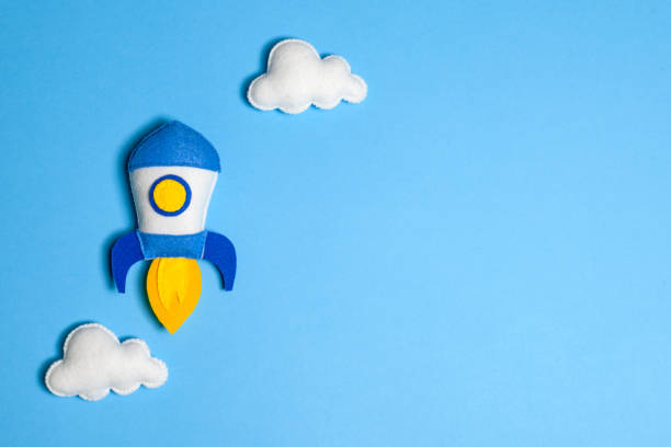 istock Rocket takes off. Space ship with white clouds on blue background. Hand made felt toys. 869278950