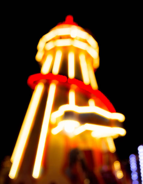 istock Lights on defocused helter skelter funfair ride 869281574