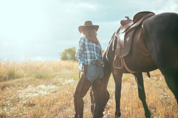 istock Woman with her horse on sunny day 869281726