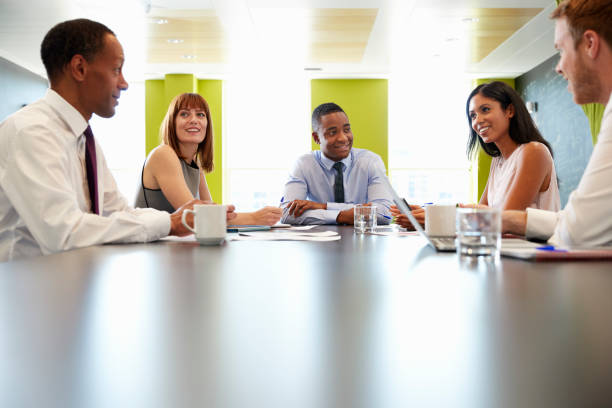 istock Business colleagues at informal meeting, surface level view 869282268