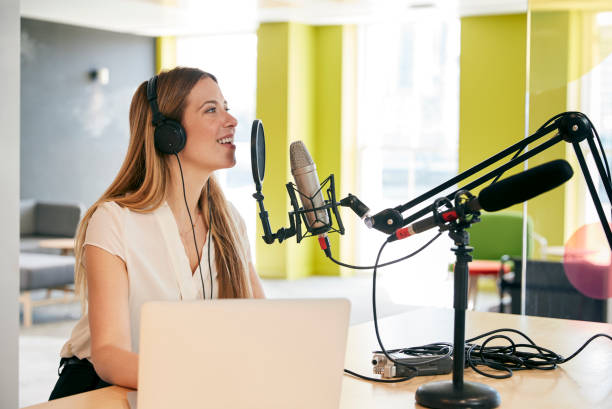 istock Young woman broadcasting in a studio, close up 869282374