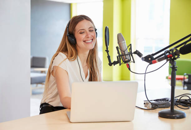 istock Happy young woman broadcasting in a studio, close up 869282428