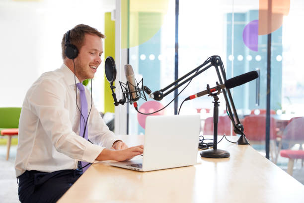 istock Happy young man recording a podcast, close up 869282508