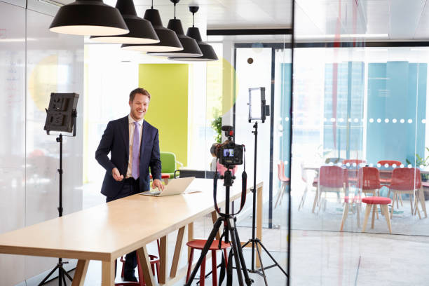 istock Young white man making a corporate demonstration video 869282618