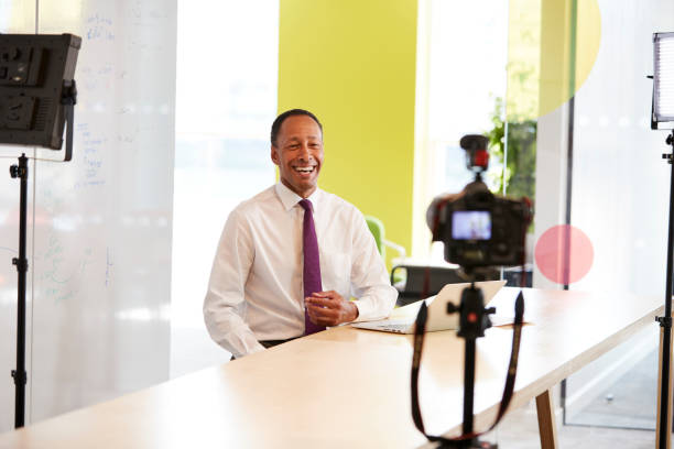 istock Middle aged businessman making a corporate video 869282670
