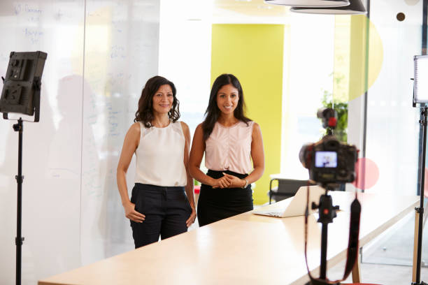 istock Two women making a corporate demonstration video 869282842