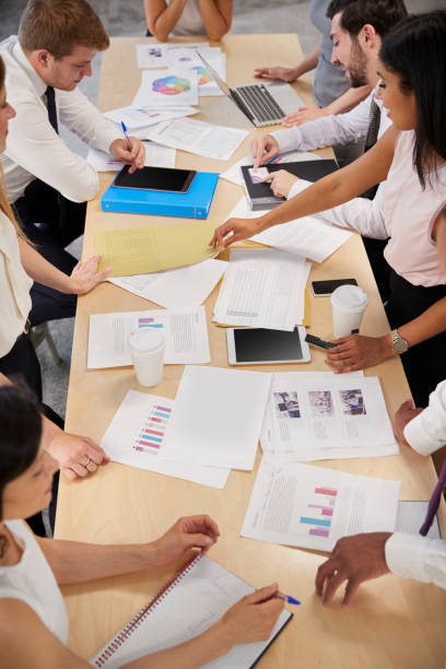istock Business group brainstorming at a table, elevated close up 869283274