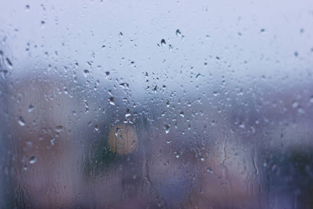 istock Rain drops on the wet window. Gray dampness 869285750