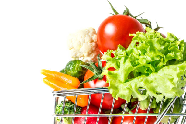 istock Shopping cart with fresh vegetables close-up isolated on white background 869285806