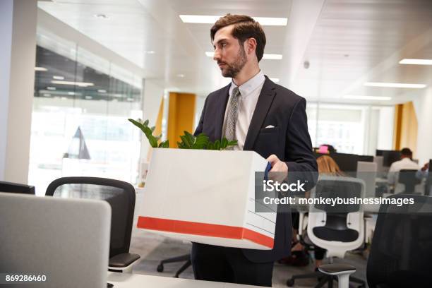 Fired Male Employee Holding Box Of Belongings In An Office Stock Photo - Download Image Now