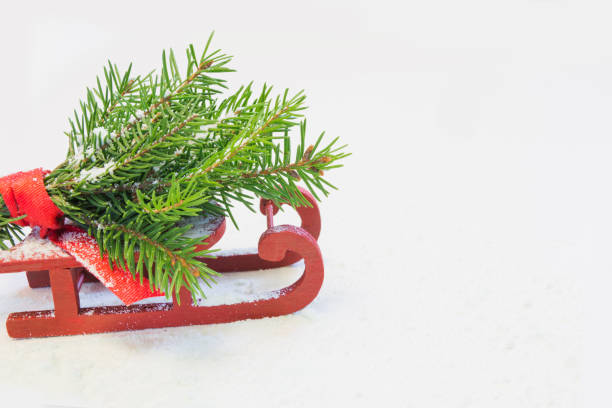 istock Christmas tree on red sled on a white background. Copy space. Holyday card. Close up. 869287582