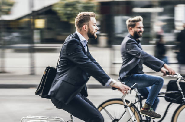 istock Two Young Businessmen Commuting With Bikes 869287808