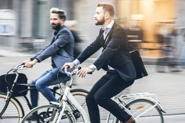 istock Two Young Businessmen Commuting With Bikes 869287880