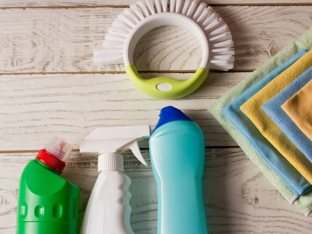 istock Colored microfiber napkins, cleaning agent, spray and brush on the white floor. 869288012