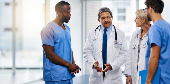 Shot of a team of doctors having a discussion in a hospital