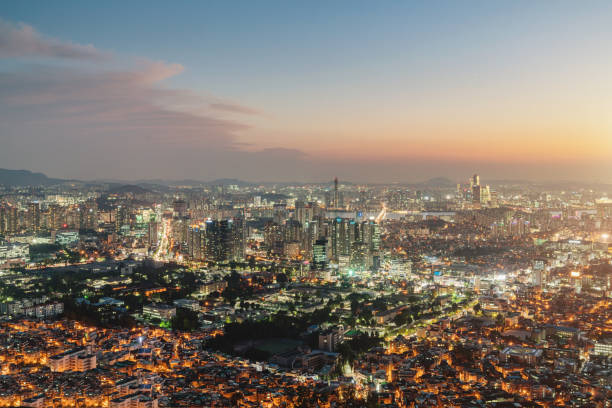 Illuminated aerial view of downtown Seoul City Skyline during a beautiful sunset. Seoul, South Korea, Asia.