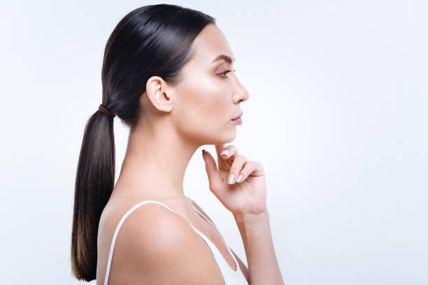 istock Side view of a beautiful dark-haired woman with pony tail 869295358