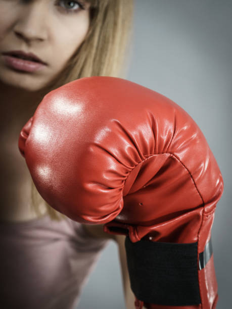 istock Woman wearing boxing gloves 869298766