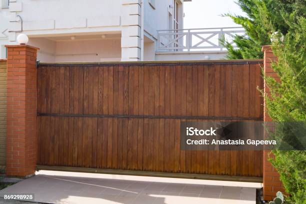 Brown Automatic Wooden Gates Of Private House Stock Photo - Download Image Now - Gate, Wood - Material, Automatic