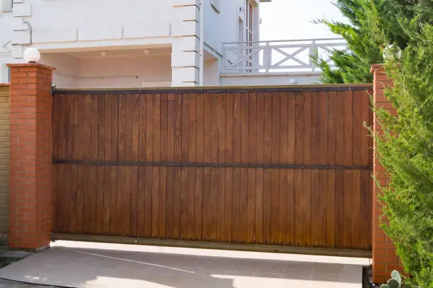 Photo of Brown automatic wooden gates of private house