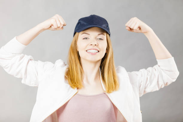 istock Young woman showing her arm muscles 869301834