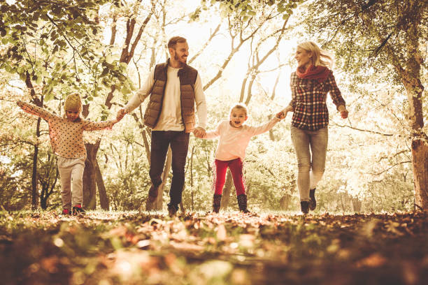 istock Family in autumn park. 869302440