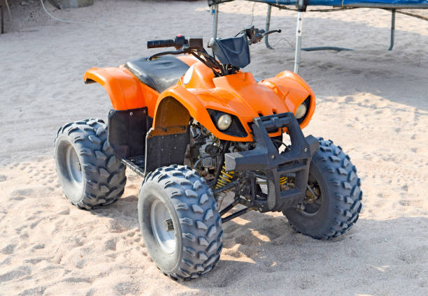 Small ATV rentals Small ATV rentals. Rental services on the beach by the sea. 4 wheel motorbike stock pictures, royalty-free photos & images