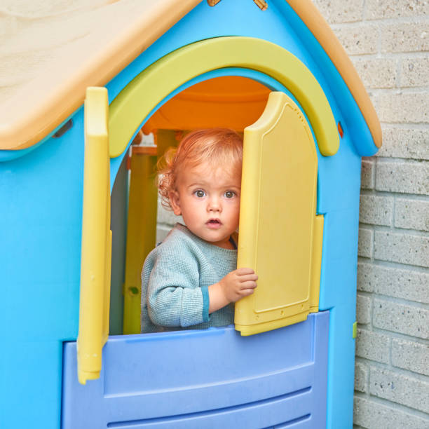 istock Child looking at some candle lights in the window 869310374