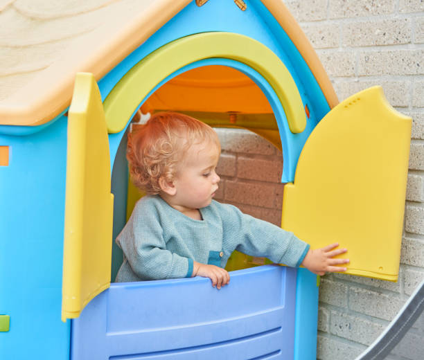 istock Child looking at some candle lights in the window 869310426
