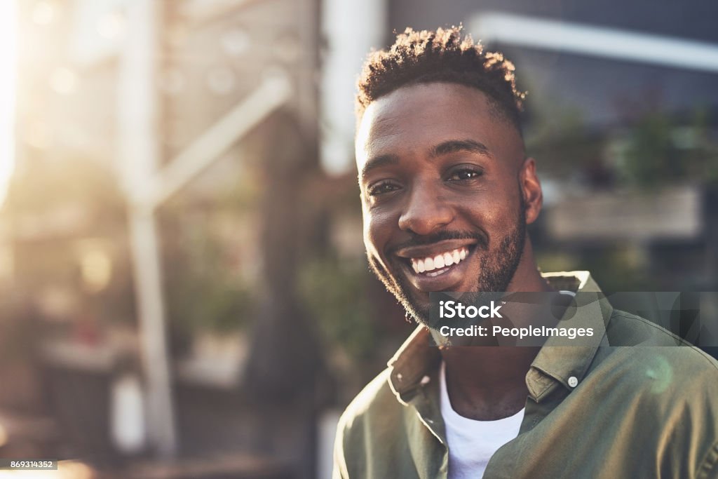 I'm happy for so many reasons Cropped shot of a handsome young man chilling at an outdoors coffee shop Men Stock Photo