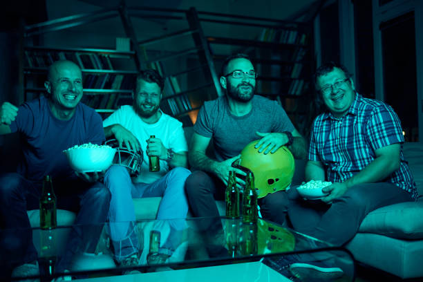 istock Four friends watching  game on TV 869319278