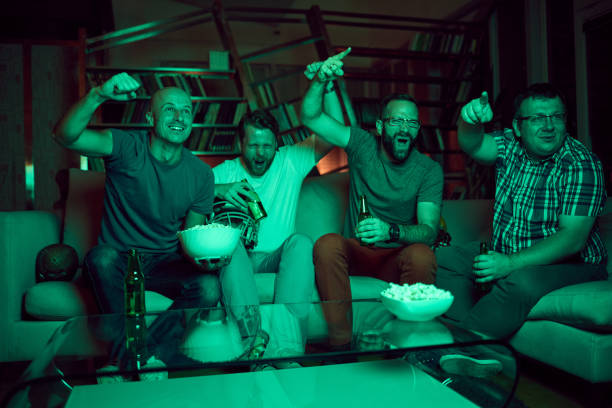 istock Four friends watching  game on TV 869320174