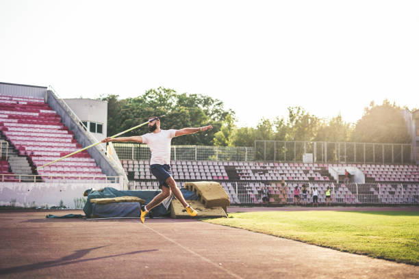 istock Athletic man trowing a javelin 869321098